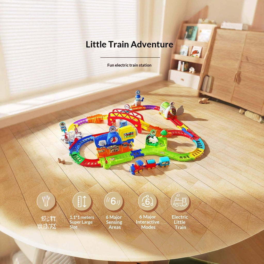 Colorful electric train set on a wooden floor with 'Little Train Adventure' text above.