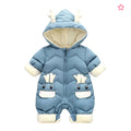 A baby's light blue hooded snowsuit with cream-colored accents, featuring a whimsical animal face design on the front and small antler details on the hood.